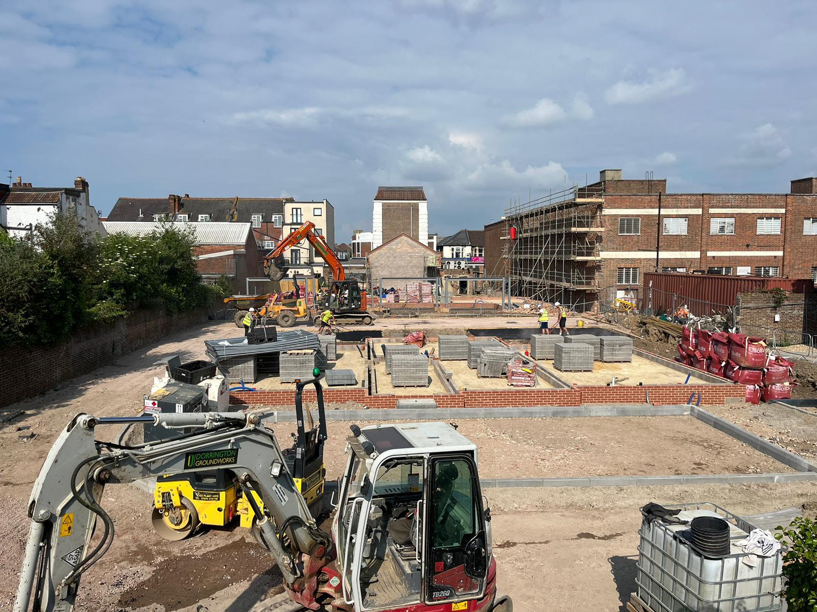 Urban foundation work with equipment and workers on active site