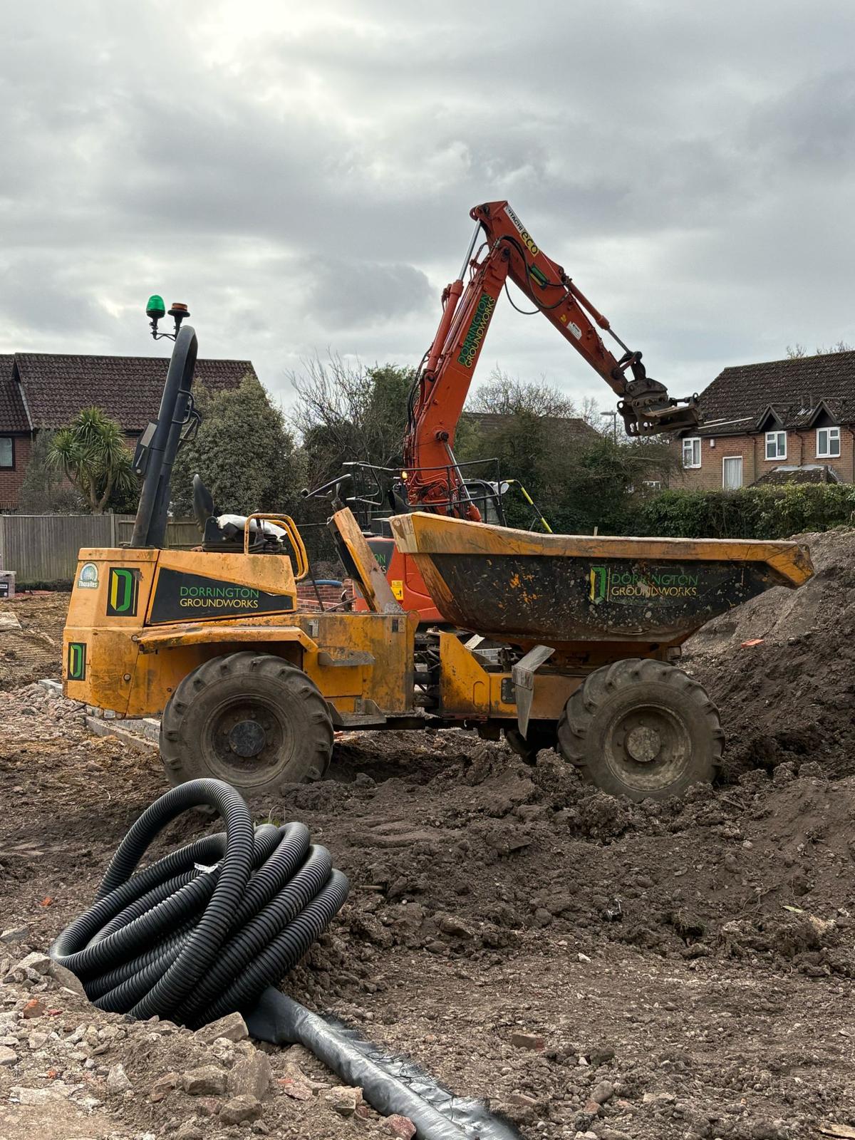 Dorrington Groundworks dumper truck operating on muddy residential site