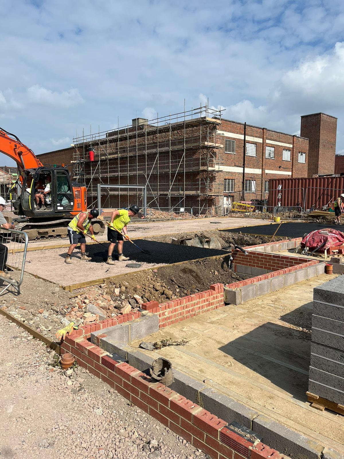 Foundation work and excavation underway at commercial building construction site