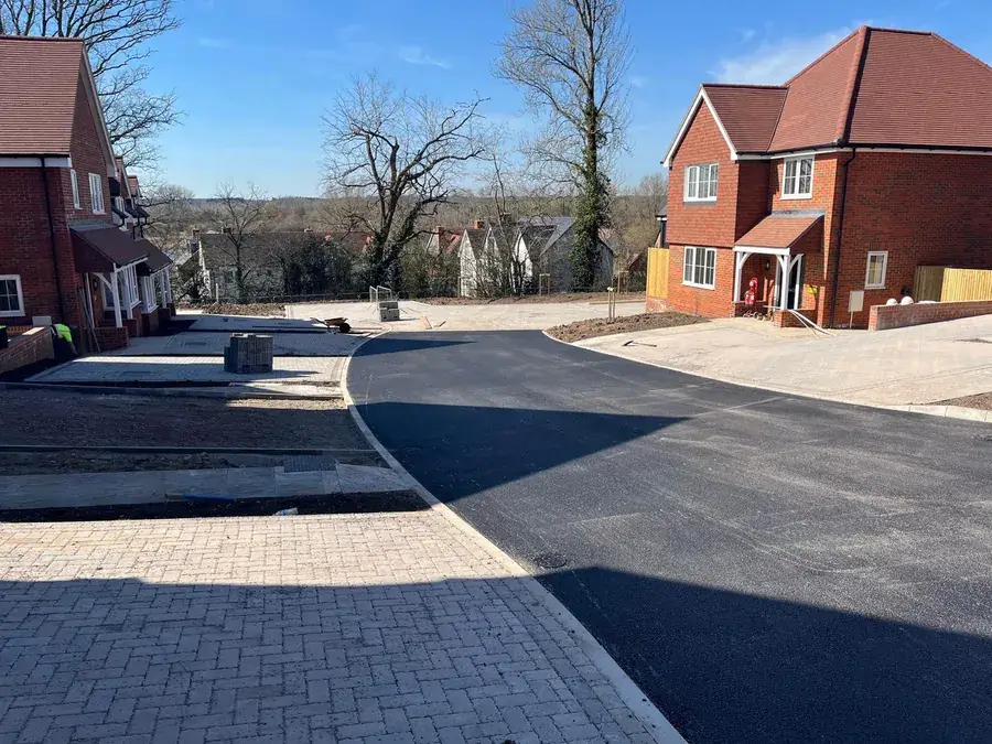 New residential junction with block paving and fresh tarmac installation